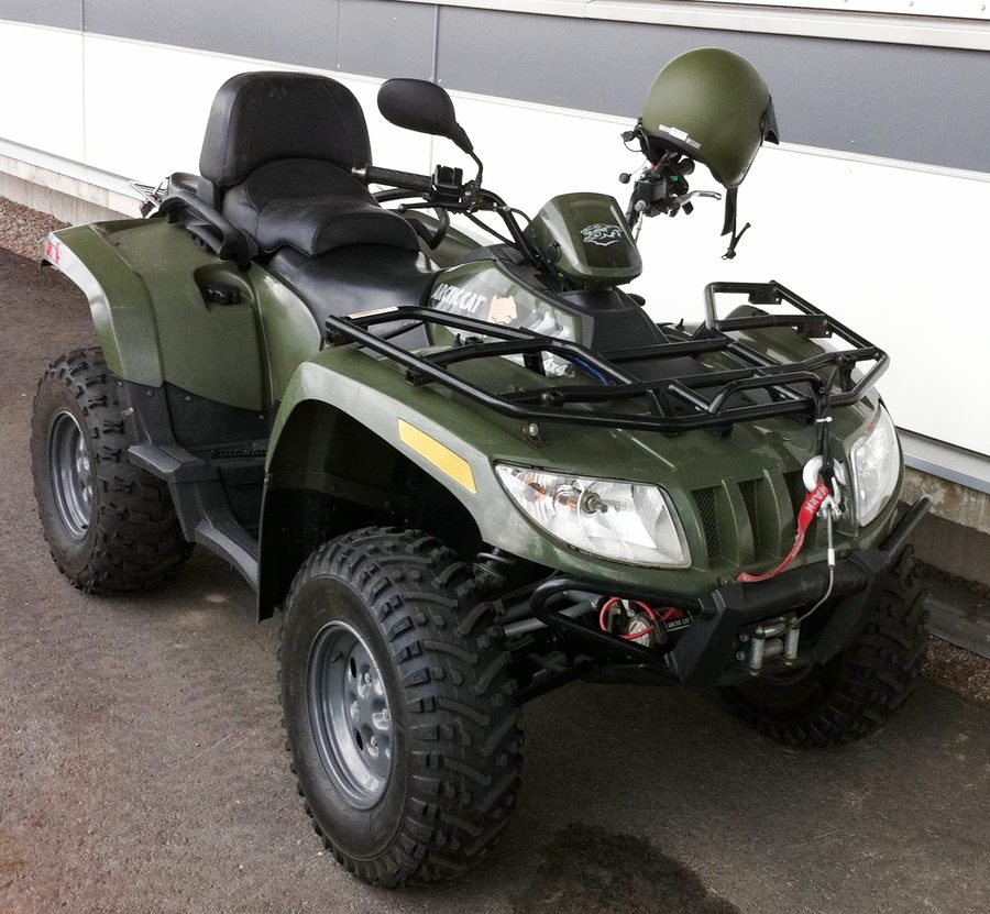 Arctic Cat utility ATV in service, wheeled four-wheeler with rear cargo rack
