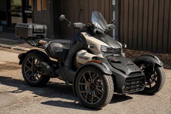 Can-Am Ryker 900 Rally in sand-tan: reverse trike with rugged front-end styling, top case, and motocross-inspired handguards