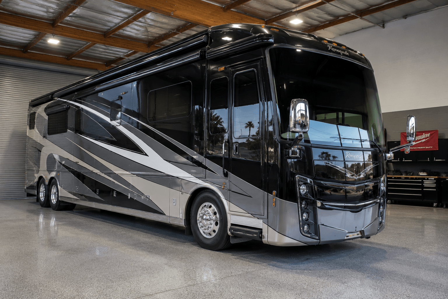 2018 Renegade XL Motorcoach luxury Class A super-C built on a heavy-duty truck chassis, glossy black exterior with silver wave graphics, tandem rear axle